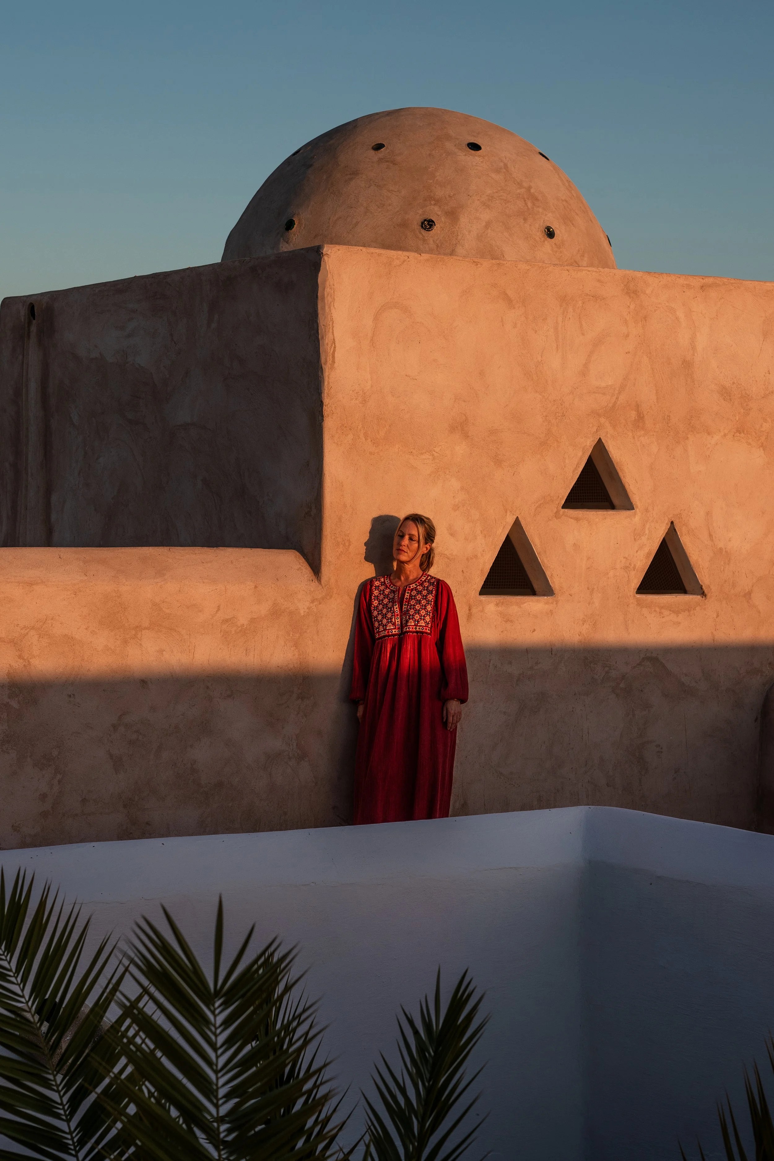 Filippa Knutsson standing on a rooftop terrace at sunset